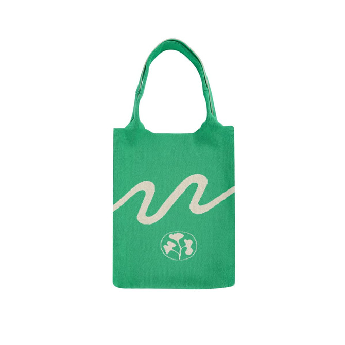 A large green knitted shoulder bag featuring a white wave design and a logo at the bottom.