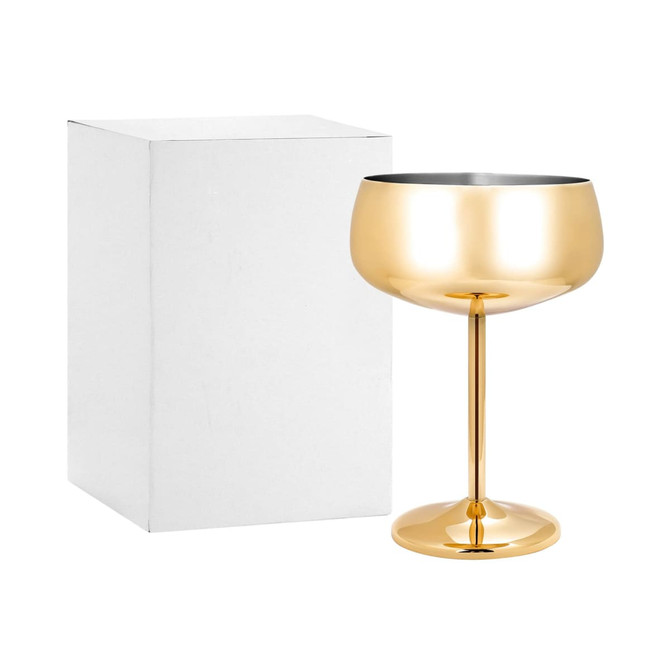 A stainless steel cocktail coupe in a shiny gold finish, next to a plain white box.