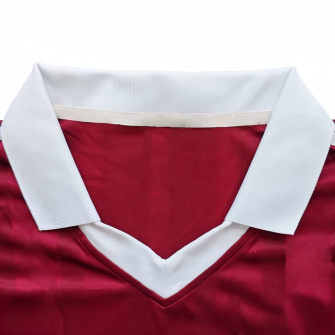 A red jersey featuring a white collar, made from 100% polyester milk silk. It has a logo on the fabric.