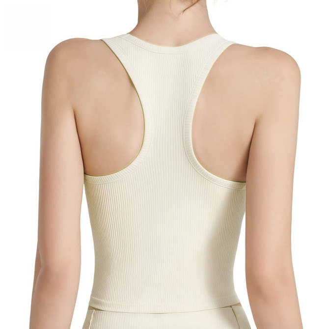 A seamless women's yoga bra tank in cream, featuring wide straps and a racerback design. It has a logo on it.