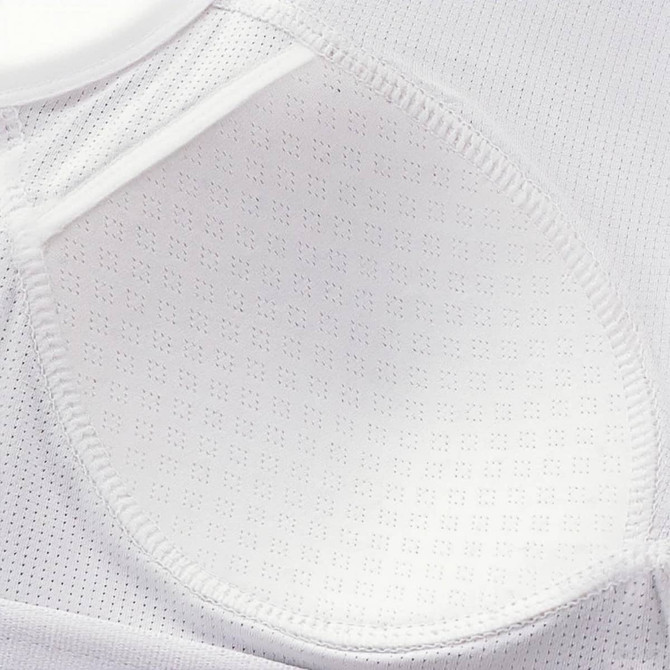 A white seamless wide-strap racerback yoga bra tank featuring a breathable, textured fabric interior and logo detail.
