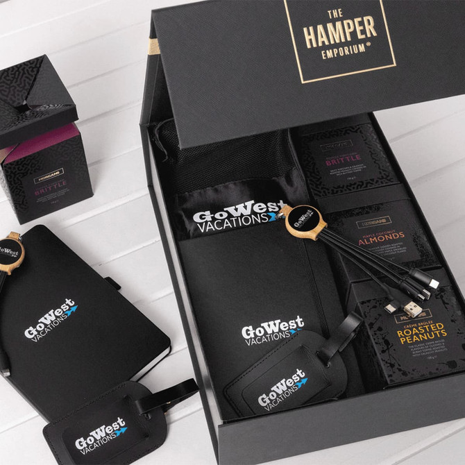 A custom travel kit featuring a black bag, snack packs, luggage tags, and a logo.