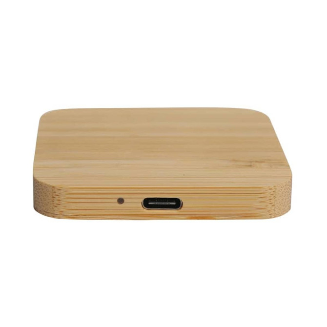 A rectangular bamboo wireless charger with a USB-C port on the side. The surface is smooth and natural in colour.