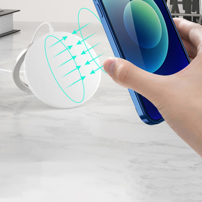 A white magnetic wireless charging stand with a smartphone being positioned above it, showcasing its charging feature. A white magnetic wireless charging stand with a smartphone being positioned above it, showcasing its charging feature.