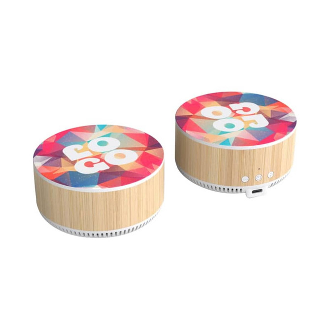 A wireless charging speaker with a colourful geometric design and a bamboo base. It features buttons and a charging port.