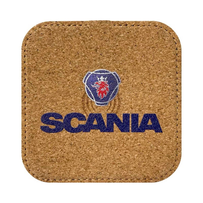A square cork wireless charger with a logo printed in blue and red, featuring a lion design and the word "SCANIA".