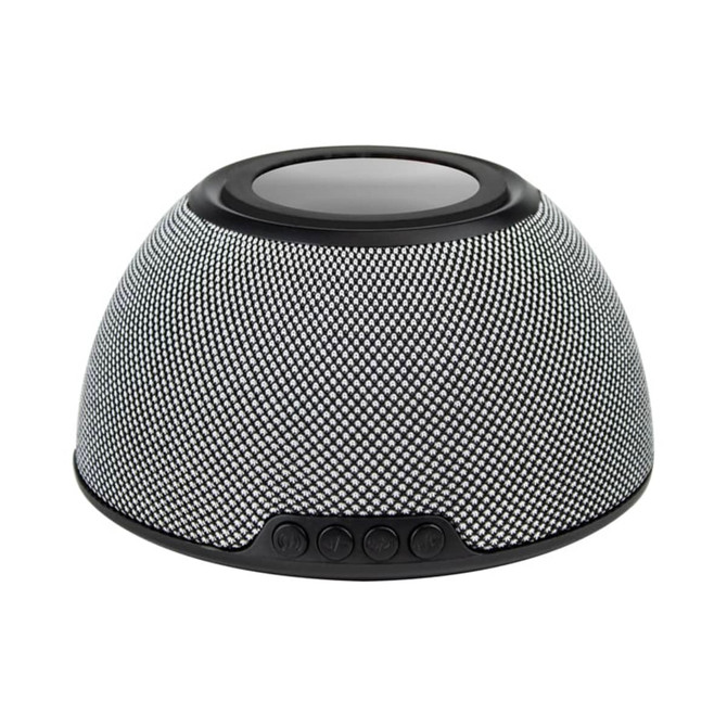 A black and silver wireless charging speaker with a textured surface and control buttons at the front, featuring a logo.