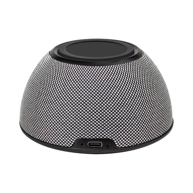 A round, textured speaker in black and silver, featuring a wireless charging surface and a USB-C port.
