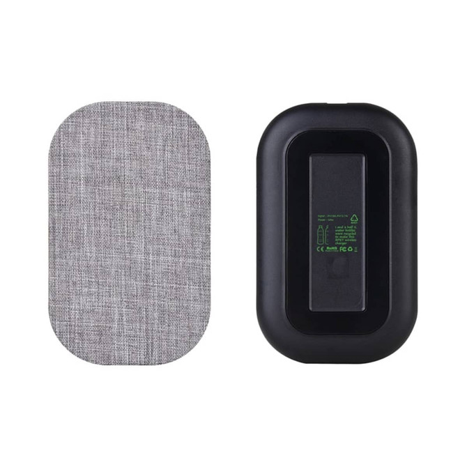 A wireless charger with a textured grey fabric surface and a black body, featuring a logo on one side.