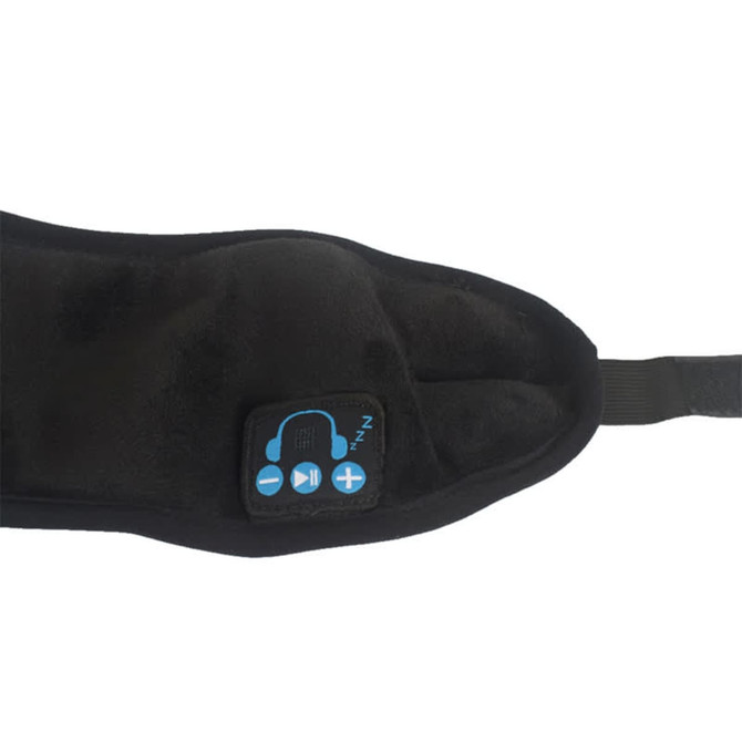 A black Bluetooth eye mask with built-in speakers and control buttons. It features a soft, plush fabric.