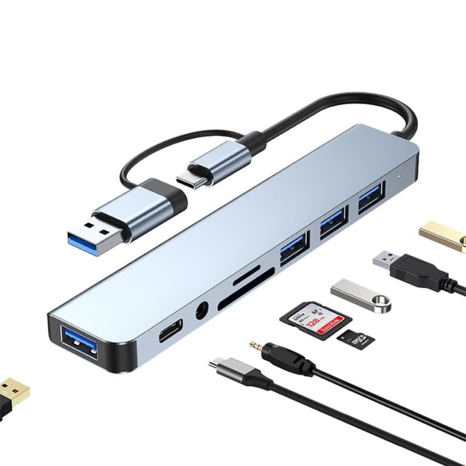A metallic silver USB hub with multiple ports, including Type-C, Type-A, and card reader slots.