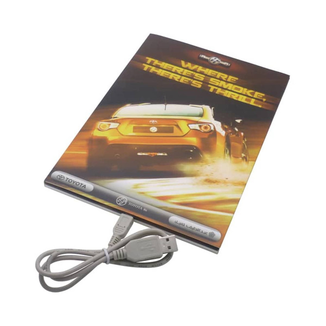 A video catalogue with a colourful cover featuring a car and a USB cable attached at the bottom.