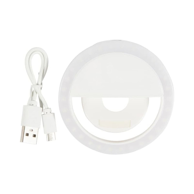 A white circular LED selfie light with a USB charging cable. The light features a ring design for illumination.