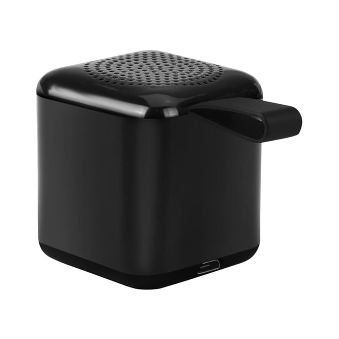 A black mini cube Bluetooth speaker with a textured top and a side handle, featuring a logo.