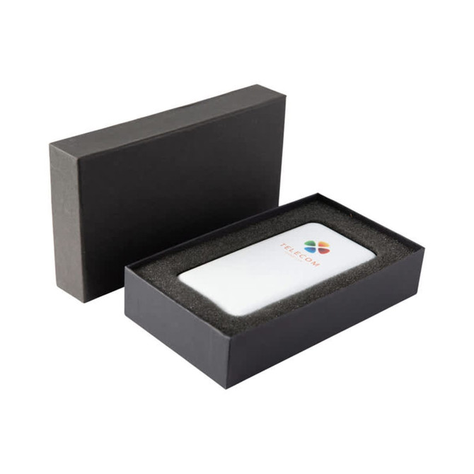 A white power bank with a logo, presented in a black gift box with foam padding.