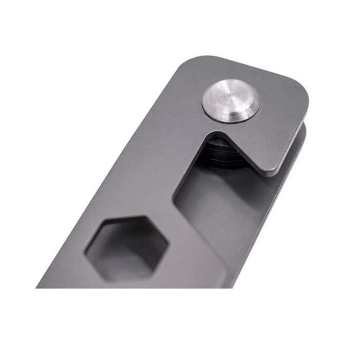 A grey metal keyring tool featuring a hexagon shape and a circular fastener. Includes a branded logo.
