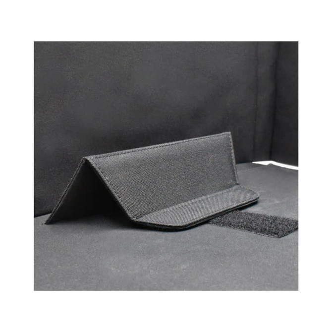 A black fabric laptop bag with a structured design and a Velcro closure. It features a textured surface.