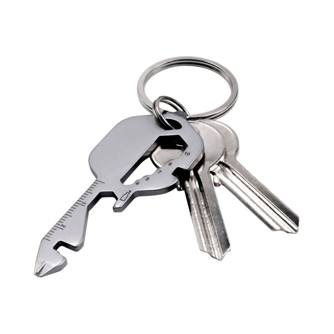A multi-tool keyring in metallic grey with several standard keys attached. The tool features measuring lines and a unique shape.