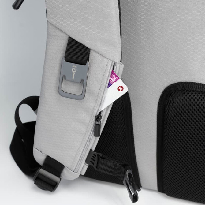 A grey eco backpack features a zippered pocket on the side with a small card partially visible inside.