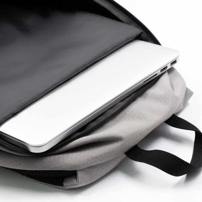 A grey eco-friendly backpack with a laptop partially visible inside its compartment. It features a logo.