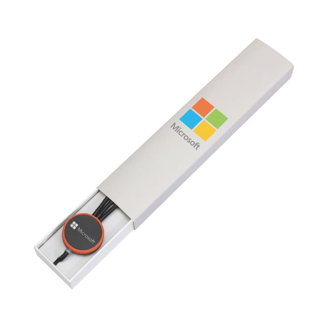 A white gift box containing a black cable and a round attachment, featuring a logo.