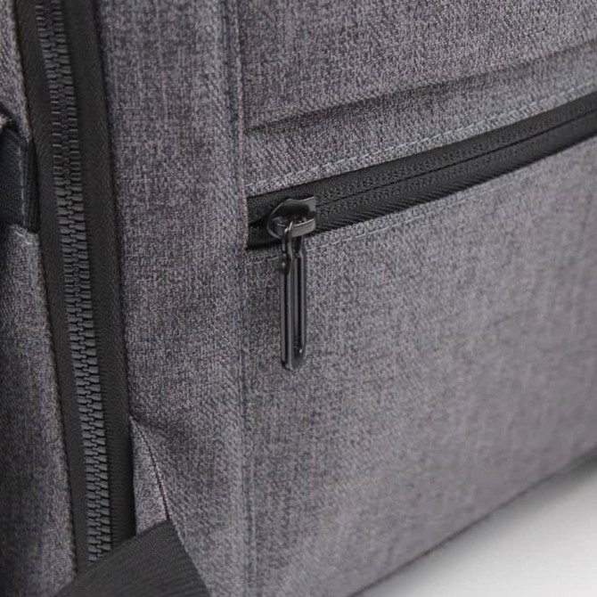 A grey backpack featuring a zippered pocket, with a sleek, textured fabric and subtle branding.