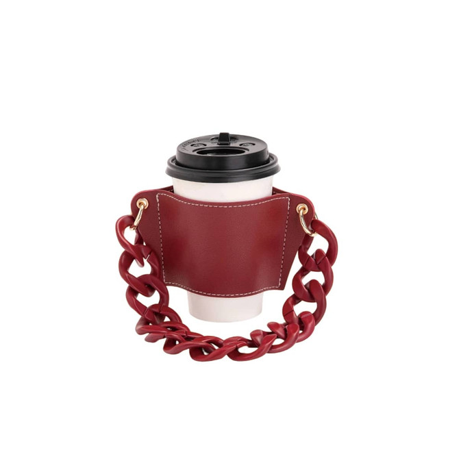A drink bottle holder in burgundy leather, featuring an acrylic strap and a cup secured within.