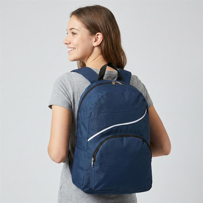 A navy blue backpack with a zippered front pocket and a logo, being worn by a young woman.