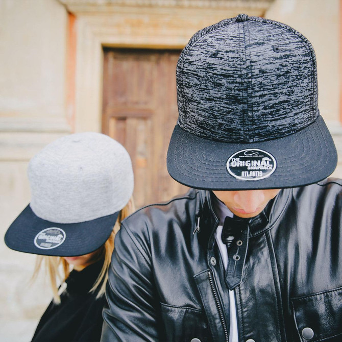 Two caps are displayed; one is grey and the other is black, both featuring a logo on the front.