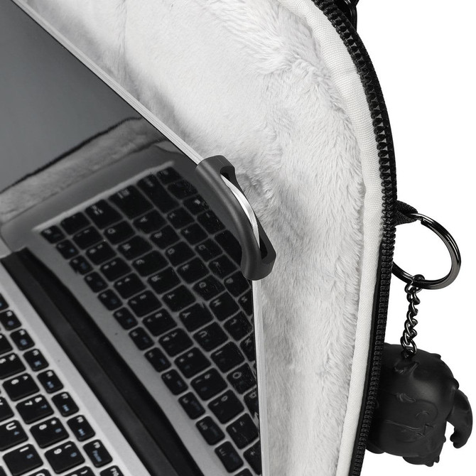 A laptop sleeve in grey with a plush interior and a keychain attachment. It features a black logo.
