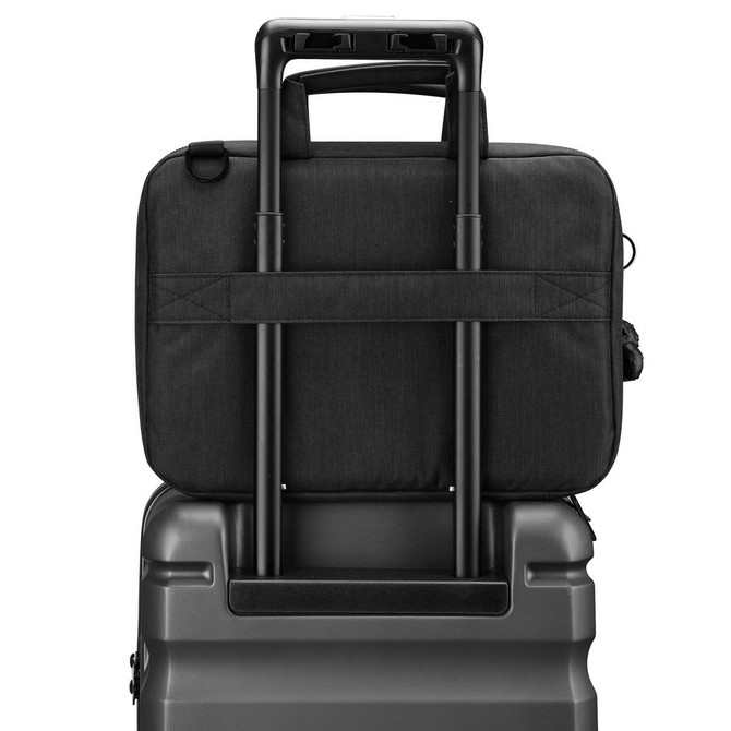 A black laptop sleeve with a handle, positioned on top of a suitcase, showcasing its sleek design.