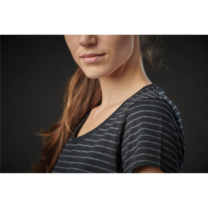 A close-up of a woman's upper body wearing a black and grey striped crew neck tee, featuring a casual fit.