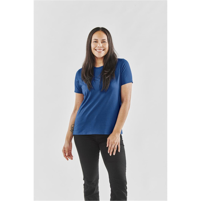 A blue women's t-shirt with a relaxed fit, modelled by a woman standing against a plain background.