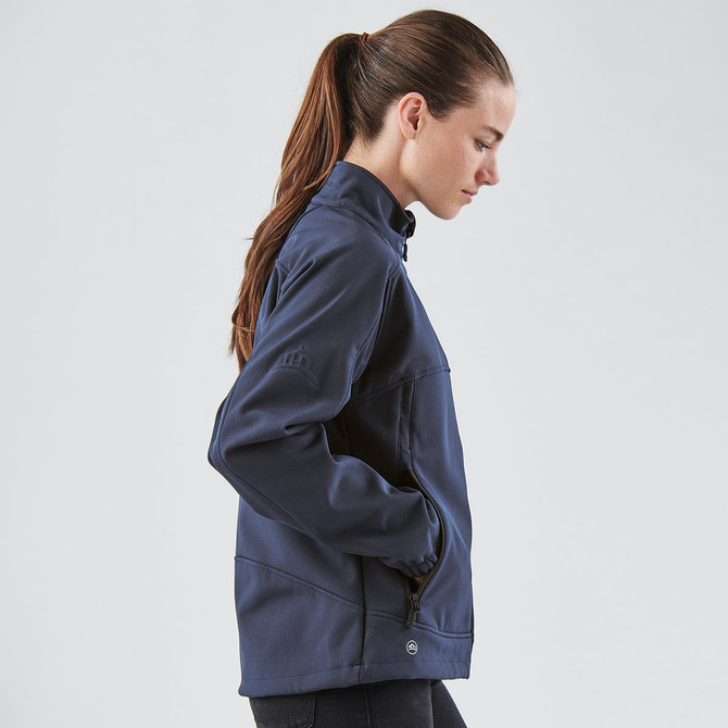 A navy women's Cirrus Bonded Jacket with a high collar and zippered pockets, featuring a logo.