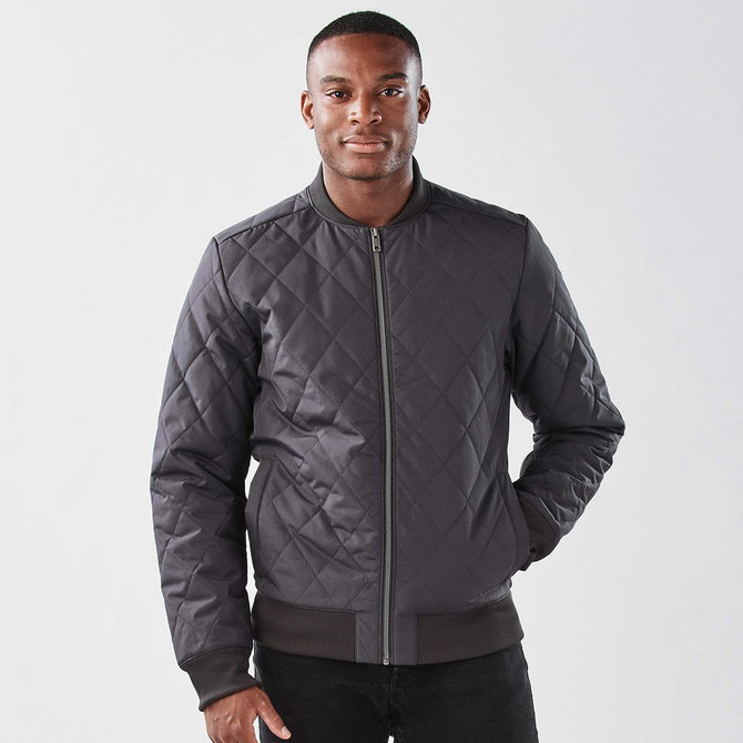 A men's thermal jacket in dark grey with a quilted pattern and a zip front, featuring a logo on the left chest.