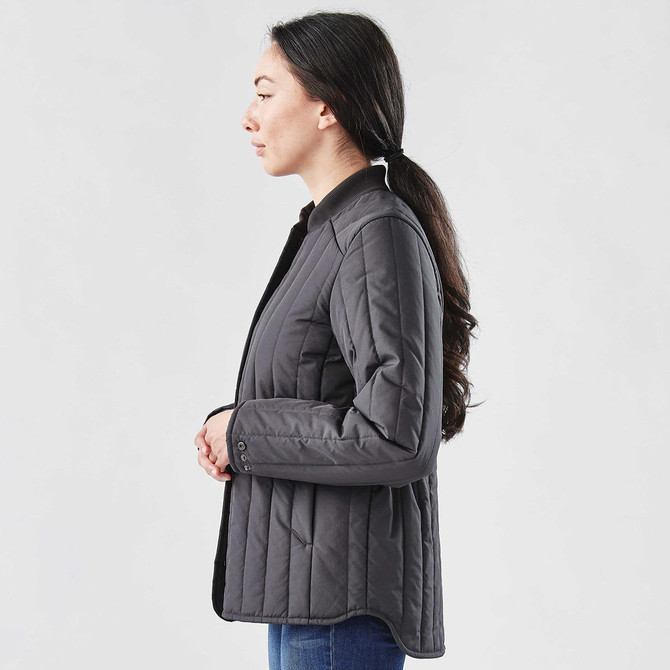 A black thermal jacket with a quilted design, featuring a collar and buttons, displayed on a model from the side.