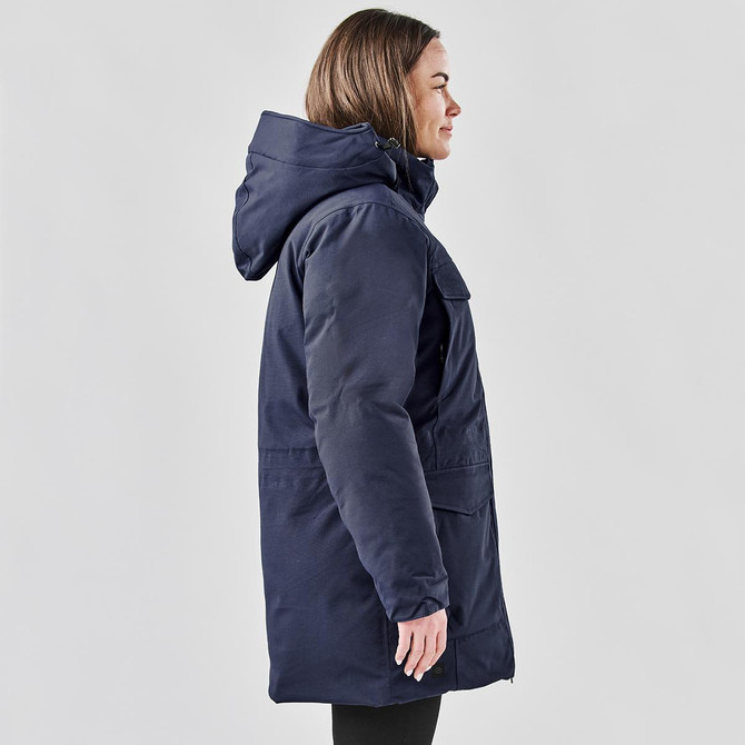 A navy blue Women's Denali Parka jacket featuring a hood and side pockets, displayed on a model.