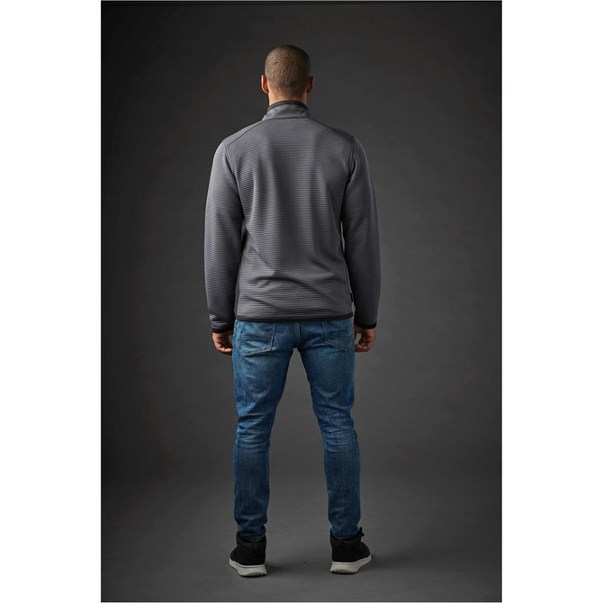 A man is wearing a grey Men's Andorra Jacket, standing with his back to the camera, paired with blue jeans.