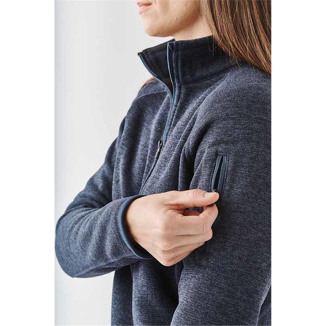 A women's dark navy 1/4 zip pullover, featuring a zippered pocket on the left sleeve and a snug collar.