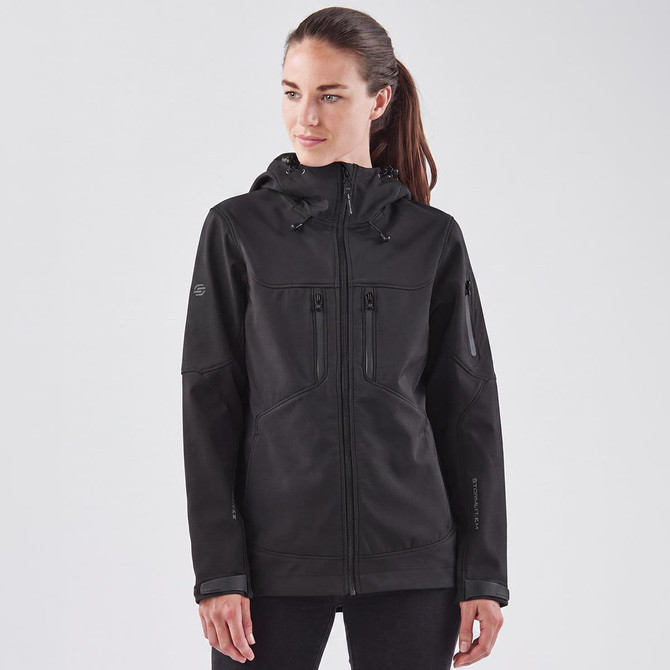 A black softshell jacket with a hood, featuring multiple zippered pockets and a logo.