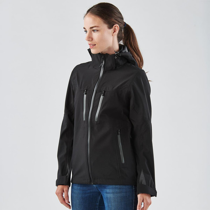 A black women's softshell jacket featuring zippered pockets and a hood, with subtle reflective accents.