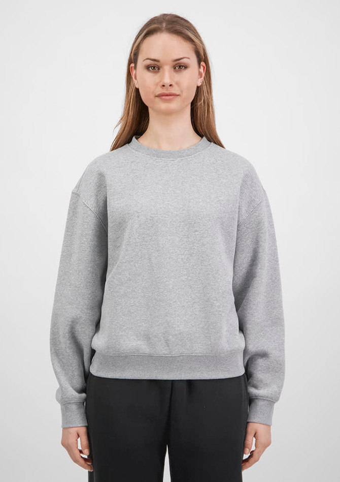A grey women's crew sweatshirt is displayed, featuring long sleeves and a relaxed fit, with a logo on the front.