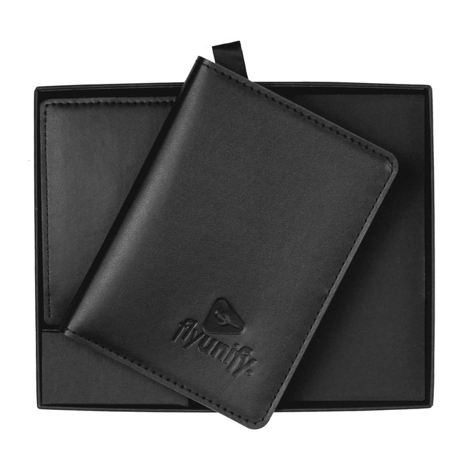 A black travel wallet resting in a sleek black box, featuring a subtle logo on the front.