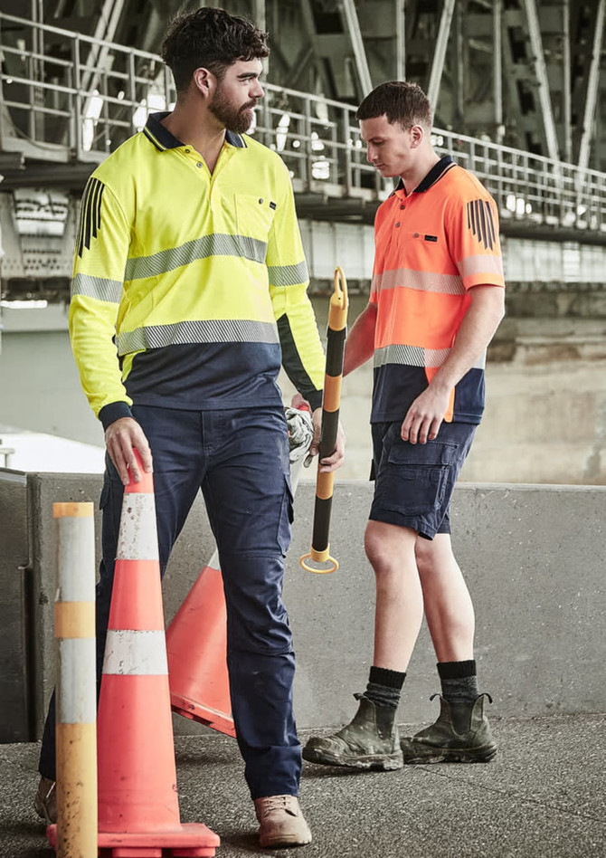 A long sleeve polo in high visibility yellow and orange with reflective tape, worn by two men in work settings.