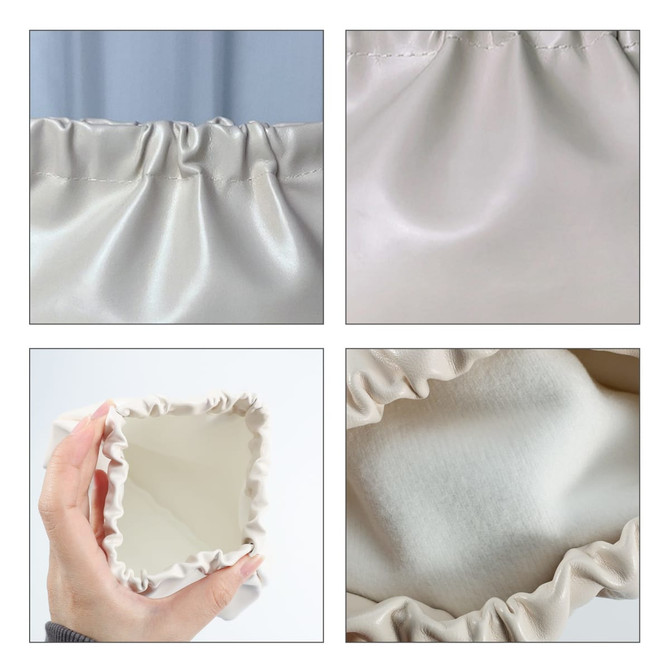 A cream-coloured, zipperless portable makeup bag with a gathered fabric design and a soft interior.