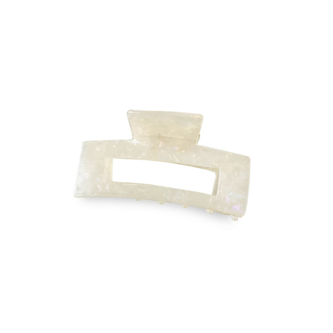 A large, iridescent hair claw clip in an elegant rectangular shape, featuring a logo on the side.