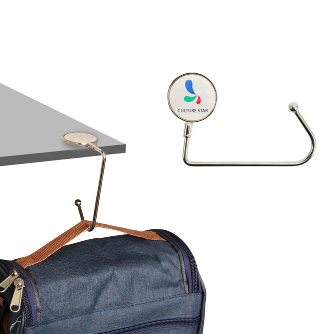 A round straight desk hook in stainless steel, designed to hang bags, featuring a logo on the base.