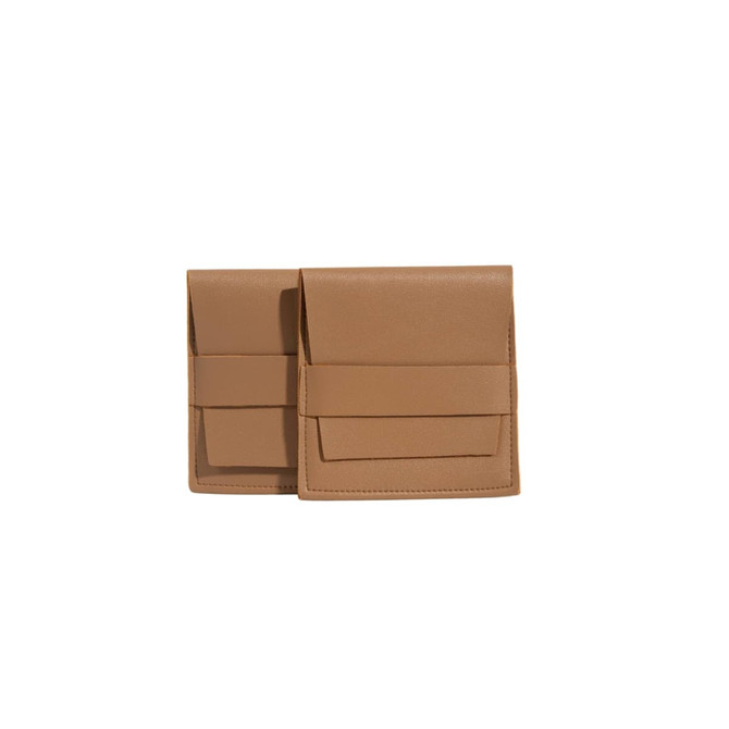 A set of tan PU leather flip jewelry pouches with pockets, featuring a sleek design and a logo.