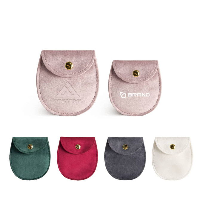 Oval velvet jewelry pouches in various colours: pink, green, burgundy, grey, and white, featuring a snap closure and branding.