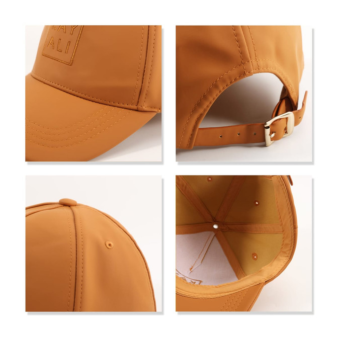 A PU leather baseball cap in a warm tan colour featuring a logo, adjustable strap, and a lined interior.